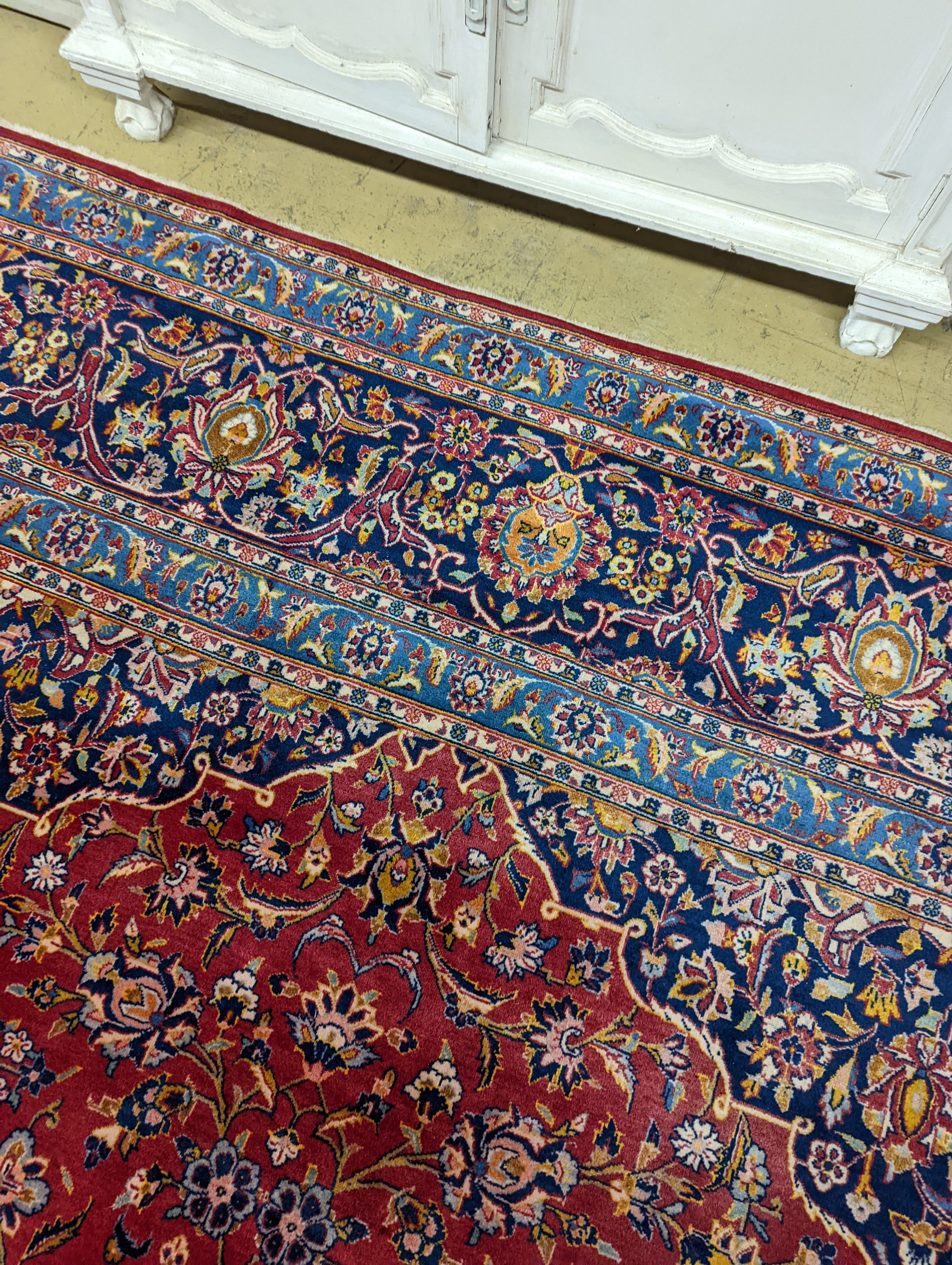 A large Tabriz red ground floral carpet, 540 x 350cm